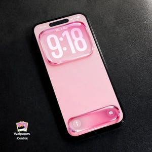 May include: A pink smartphone with a black frame displays the time, 9:18, in white. The screen features a translucent, bubble-like design at the top and bottom. The phone's screen is a solid pink color. The phone is on a dark surface.