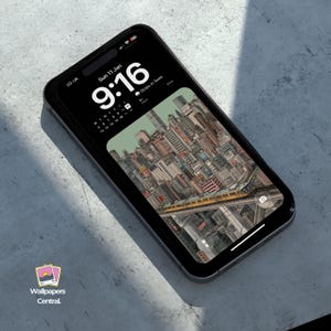 May include: A black smartphone displays a cityscape wallpaper with a yellow train. The screen shows the time as 9:16 AM and the date as Sunday, January 11th. The phone is on a gray surface, with the "Wallpapers Central" logo visible.