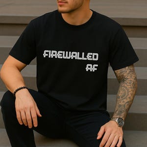 May include: Black crew neck t-shirt with the white text "FIREWALLED AF". The shirt is made of a soft material and has short sleeves. The text is in a bold, sans-serif font.