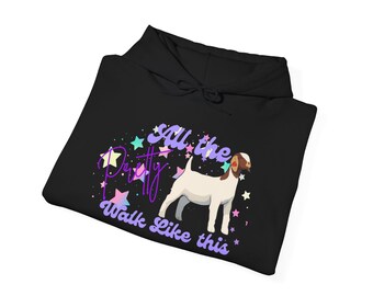 Puede incluir: Sudadera con capucha negra con un gráfico de cabra y el texto "All the Pretty Walk Like this". La cabra es blanca con marcas marrones, rodeada de estrellas de colores. El texto es en morado y blanco.