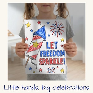 May include: A child holding a white paper with a hand-drawn illustration of a firework rocket, stars, and fireworks. The text "LET FREEDOM SPARKLE!" is written in blue and red. The image is a patriotic theme.