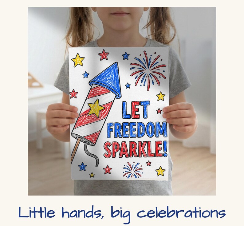 May include: A child holding a white paper with a hand-drawn illustration of a firework rocket, stars, and fireworks. The text "LET FREEDOM SPARKLE!" is written in blue and red. The image is a patriotic theme.