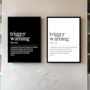 May include: Two framed art prints with the words "trigger warning" in a bold, sans-serif font. One print has a black background with white text, the other has a white background with black text. The definition is included.