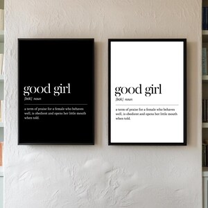 May include: Two framed art prints with the text "good girl" in a bold, modern font. The definition of "good girl" is included below the title. One print has a black background, the other is white.