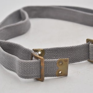 May include: A set of three ceramic mugs with a speckled, matte finish. Each mug features a different color: light blue, cream, and gray. The mugs have a simple, modern design and a comfortable handle.