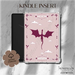 May include: A Kindle Insert with a pink background featuring a maroon dragon illustration, clouds, and floral accents. The text "TAKE ME TOO" and "BASIATH" are displayed. The words "KINDLE INSERT" are at the top.