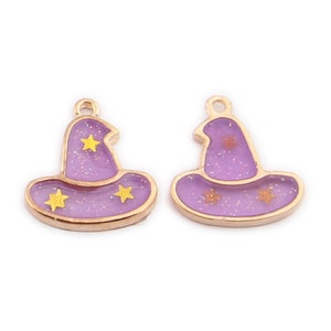 May include: Two gold-toned charms shaped like purple witch hats with gold glitter and yellow stars.