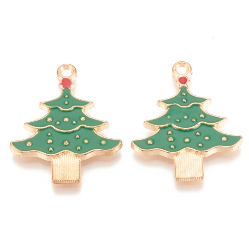 May include: Two gold-tone Christmas tree charms with green enamel and red accents. The charms have a loop at the top for hanging.