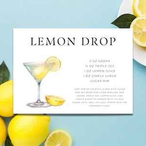 May include: A white card with the text "LEMON DROP" and a watercolor illustration of a cocktail in a martini glass with a lemon slice. The recipe includes vodka, triple sec, lemon juice, and simple syrup.
