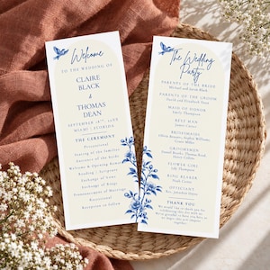May include: Two vertical wedding program cards with a cream-colored arch background, blue floral illustrations, and a small blue bird. The text includes "Welcome to the wedding of Claire Black & Thomas Dean" and "The Wedding Party" with names.