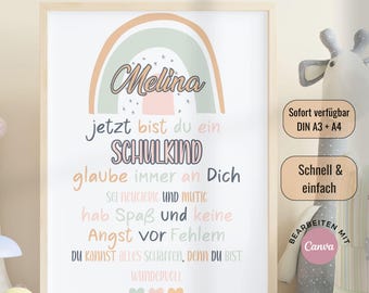 May include: A framed print with a rainbow design and the name "Melina" in cursive. The print includes inspirational text in German, with the words "SCHULKIND" and "WUNDERVOLL" highlighted. The frame is light brown.