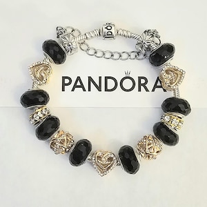 May include: A white ceramic mug with a black handle and the text "But First, Coffee" in a black, bold font. The mug is on a white surface.