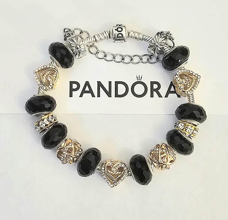 May include: A white ceramic mug with a black handle and the text "But First, Coffee" in a black, bold font. The mug is on a white surface.