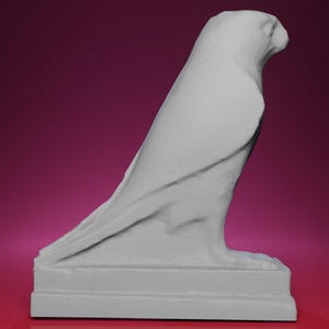 May include: A gray sculpture of a bird of prey, possibly a falcon or hawk, with detailed feather and wing textures. The bird is perched on a rectangular base, set against a dark pink background. The sculpture is a side profile.