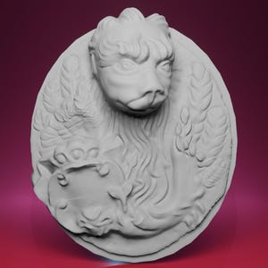 May include: A white, oval-shaped relief sculpture featuring a central animal head with detailed fur and facial features. The sculpture includes decorative elements such as feathers and foliage, creating a classical aesthetic.