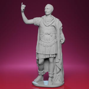 May include: A grey statue of a man in classical Roman attire, including a tunic, armour, and a draped cloak. The figure is depicted with one arm raised, index finger pointing upward. The statue is on a base.