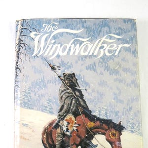 May include: A vintage paperback book titled "The Windwalker" by Blaine M. Yorgason. The cover art depicts a Native American figure riding a brown horse through a snowy landscape. The title is in a stylized font.