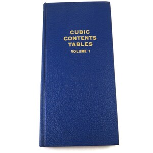 May include: A blue hardcover book titled "Cubic Contents Tables, Volume 1".