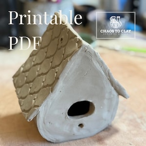 May include: A handcrafted, unglazed clay birdhouse with a textured roof and a circular entrance. The birdhouse is light grey and features the text "Printable PDF" in white. The logo "Chaos to Clay Ceramics & More" is also visible.