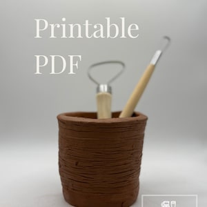 May include: A brown, textured clay cup contains two pottery tools. The cup has a rough, ridged surface. The tools include a loop tool and a ribbon tool, both with wooden handles. Text on the image reads "Printable PDF" and "Chaos to Clay Ceramics & More."