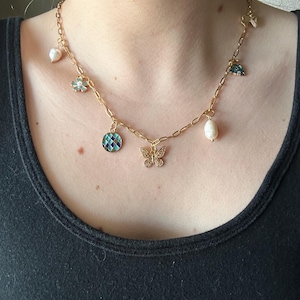 Charm necklace, pearl, jewelry, gold, butterfly, bow