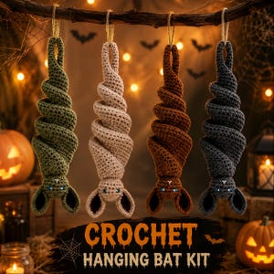 May include: Four hanging crochet bats in olive green, beige, brown, and dark gray, each with a spiral body and two ears. The text CROCHET HANGING BAT KIT is displayed at the bottom. Each bat is suspended by a twine loop from a horizontal branch.