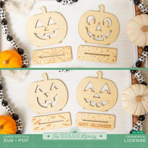 May include: Wooden laser cut Halloween decorations featuring jack-o'-lanterns and decorative bases. The bases include spiderwebs, stars, bats, and the text "BOO!" and "Happy Halloween!". The decorations are displayed with pumpkins and beads.