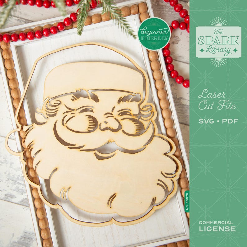 May include: A wooden Santa Claus face cutout with a smiling expression. The laser-cut design features details like a beard, hat, and facial features. The image includes text that says "Beginner Friendly", "Laser Cut File", and "Commercial License".