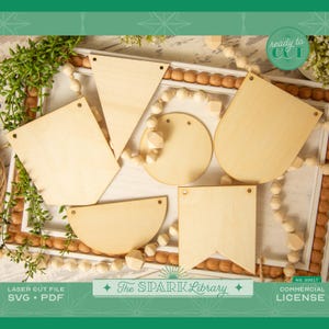 May include: A set of six unfinished wooden banner shapes, including a circle, a half-circle, a triangle, and three rectangular shapes. The shapes are arranged on a white surface with wooden beads and a green plant in the background. The text "ready to cut" is in a red circle with a white outline. The text "The SPARK Library" is in black with a white outline. The text "NO. 30017 COMMERCIAL LICENSE" is in black with a white outline.