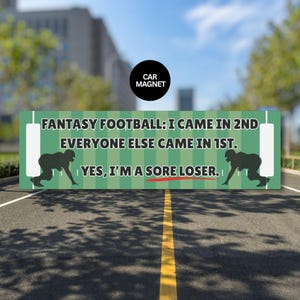 May include: Green car magnet with the text "FANTASY FOOTBALL: I CAME IN 2ND EVERYONE ELSE CAME IN 1ST. YES, I'M A SORE LOSER." Includes a black circle with "CAR MAGNET" and football player silhouettes.