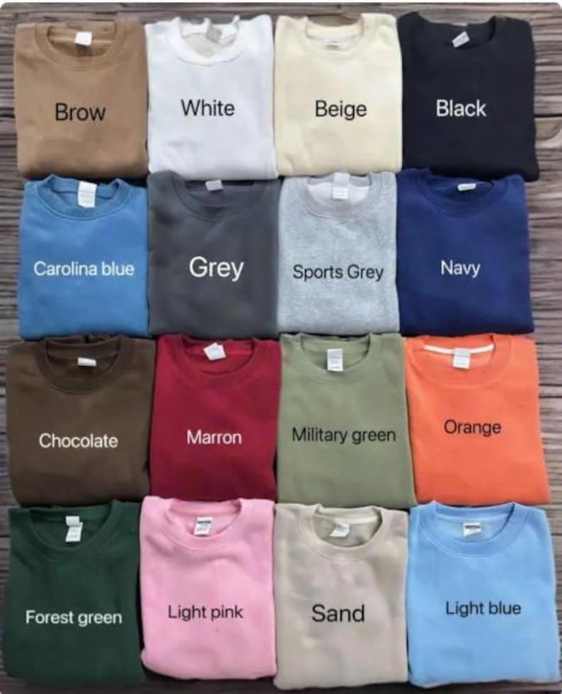 May include: A collection of crewneck sweatshirts in various colors, including brown, white, beige, black, Carolina blue, grey, sports grey, navy, chocolate, maroon, military green, orange, forest green, light pink, sand, and light blue. Each sweatshirt has a tag.