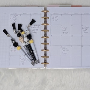 Skull beaded pens with black white & yellow details plus tassels spooky cute planner gifts perfect for Halloween or gothic stationery lovers