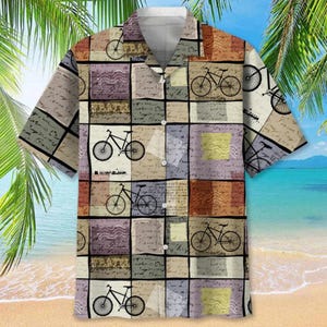 May include: Short-sleeved button-down shirt with a bicycle pattern. The shirt features a patchwork design with bicycle illustrations and script on a beige, brown, and purple background. The shirt has a classic collar and is suitable for casual wear.