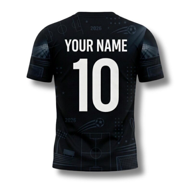 May include: Black soccer jersey with the text "YOUR NAME" above the number "10" in white. The jersey has a subtle pattern of soccer field elements and the year "2026".