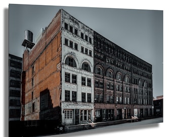 May include: An architectural photograph of a multi-story brick building with a water tower on the roof. The building has a faded appearance, with sections of red brick, white, and dark brown facades. The text "TIMEWALKER TATTOO" is visible on a storefront.