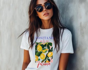 May include: White t-shirt with a graphic print of lemons on a branch. The text "POSITANO sei la mia felicita" is printed on the shirt.