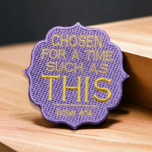 May include: Purple embroidered patch with the text "Chosen for a time such as this" in yellow thread. The text "Esther 4:14" is also embroidered in yellow thread below the main text.