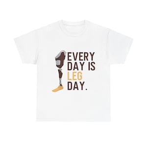 May include: White t-shirt featuring the text "EVERY DAY IS LEG DAY" in brown and yellow. A graphic of a prosthetic leg is next to the text. The prosthetic leg is brown, black, and yellow.