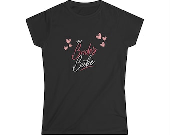 May include: Black t-shirt with the text "Bride's Babe" in pink and white script, along with pink heart and crown graphics. The shirt is a crew neck style.
