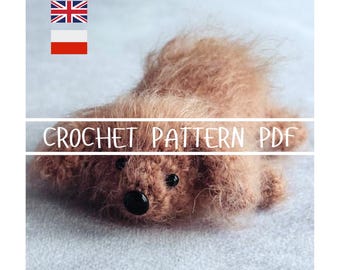 May include: A handmade brown crochet teddy bear with black button eyes and a black nose. The text "CROCHET PATTERN PDF" is displayed across the image. The bear is lying on a light gray surface.