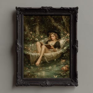 May include: A framed painting depicts a woman reading in a bathtub in a forest setting. The artwork features a black ornate frame. The woman wears a black hat and a white dress. The scene includes butterflies, flowers, and mushrooms.