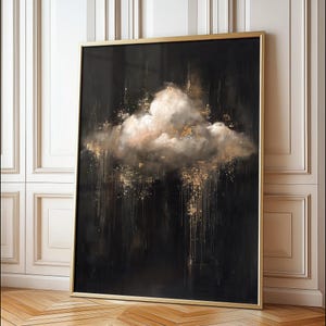 May include: Large framed abstract art print featuring a cloud formation in shades of white, gold, and peach against a black background. The artwork is enclosed in a gold frame, creating a striking contrast. The overall theme is modern and elegant.