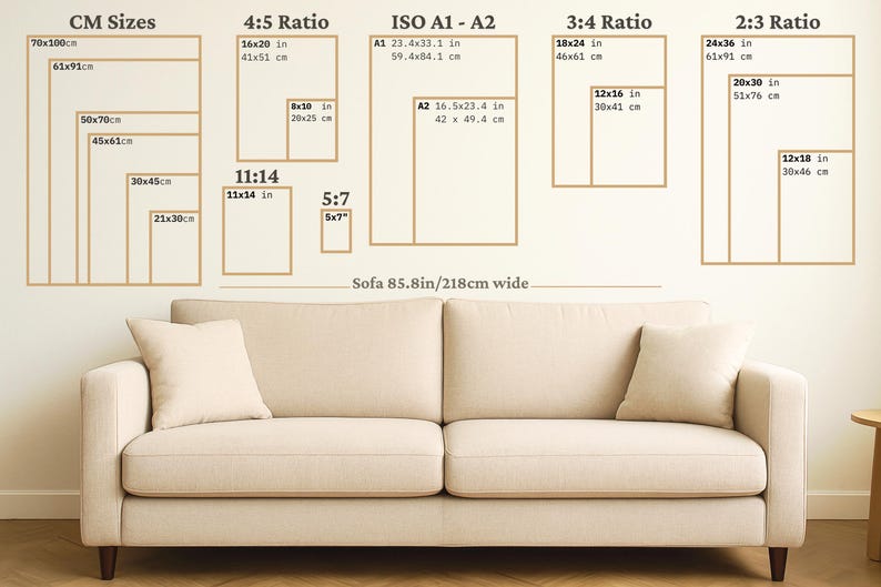 Art print size guide showing cm, ratio and inch sizes displayed above a neutral sofa for visual scale reference.