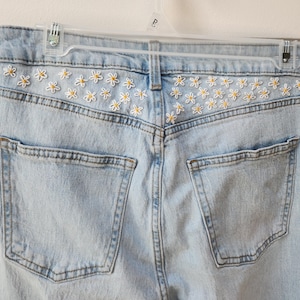 Jeans con fiori ricamati