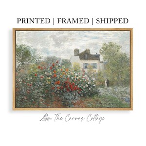 May include: A framed canvas print of a garden scene with a house in the background. The artwork features a vibrant display of red, white, and yellow flowers. The text "PRINTED | FRAMED | SHIPPED" is at the top.