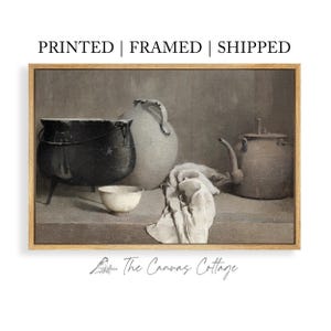 Peut inclure: Impression d'art encadrée représentant une nature morte avec une marmite noire, un bol en céramique blanc, une grande cruche blanche, une théière et un tissu drapé. Palette de couleurs neutres, de The Canvas Cottage.
