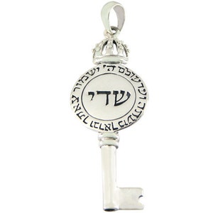 May include: Silver key pendant with a round charm featuring the Hebrew letter 'Shin' and the words 'Shema Yisrael' in Hebrew. The charm is topped with a crown.