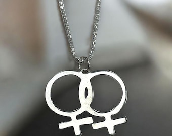 May include: A silver necklace with a double female symbol pendant.