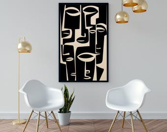 May include: A framed abstract art print featuring a black and cream-colored design of stylized faces. The artwork is displayed on a white wall, with two white chairs and a gold floor lamp in the foreground. The room has a modern aesthetic.