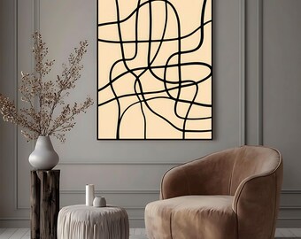 May include: Abstract art print featuring black lines on a cream background, framed in black. The artwork is displayed in a modern living room setting, with a brown armchair, a small ottoman, and a decorative vase.